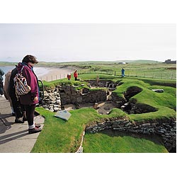 Bay of Skaill - Girl tourist prehistoric neolithic settlement house ruins tourists scotland  photo 
