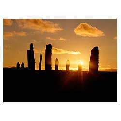 Standing stone circle - People sitting watching a sunset holiday tourists uk visiting scotland women  photo
 