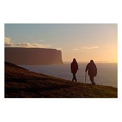 Black Craig - Two hikers on foot path Seacliffs and North Altantic Ocean dusk sunset  photo 