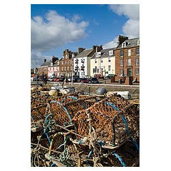 Arbroath harbour - Fishing creels alongside quay side and row of harbour houses  photo 