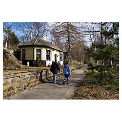 Cambus O May - Couple walking on footpath past old railway line station  photo 