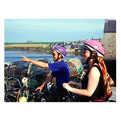 Two cyclists holiday - Cyclist helmet uk tourist cycle helmets scotland couple cycling sightseeing  photo
 