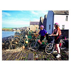 St Margarets Hope - Two cyclists sightseeing fishing village cycling uk bicycle holiday  photo 