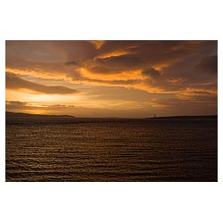 Graemsay Lighthouse - Early morning sunrise orange and grey cloudy sky Scotland sun rise cloud  photo 
