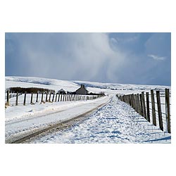 Russland - Cottage on farm roadside grey storm clouds snowscape wintery remote road  photo 